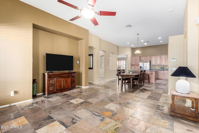 dining area with arched walkways, recessed lighting, visible vents, and baseboards