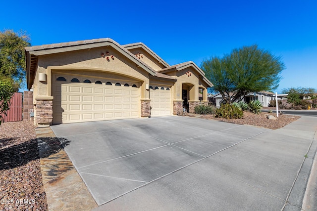 view of front of property featuring a garage, a tile roof, stone siding, concrete driveway, and stucco siding