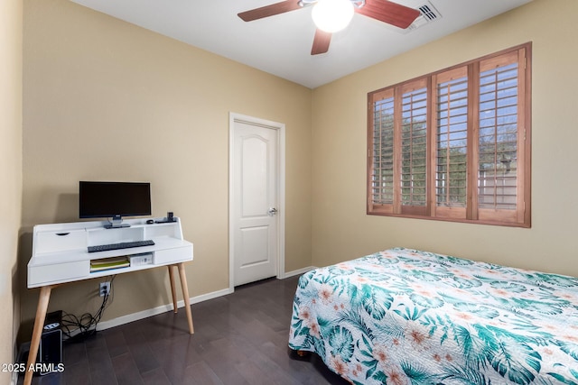 bedroom featuring dark wood-style flooring, a ceiling fan, and baseboards