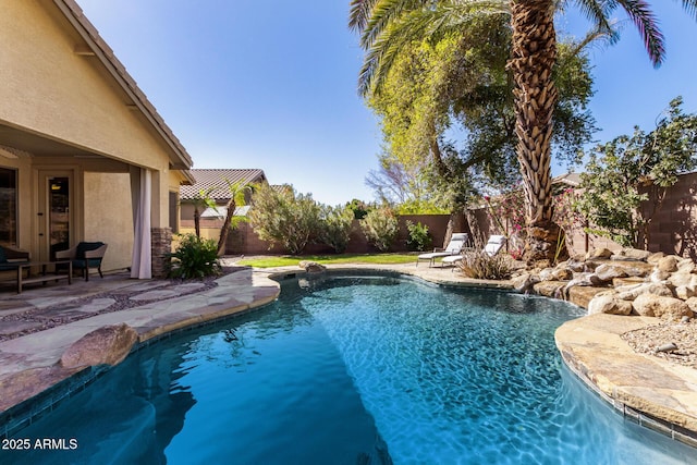 view of swimming pool featuring a fenced backyard and a patio