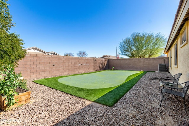 view of yard featuring a fenced backyard and central air condition unit