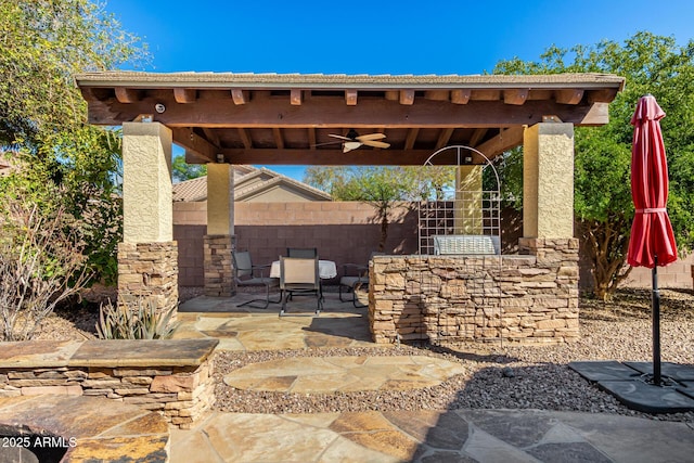 view of patio featuring fence and a ceiling fan