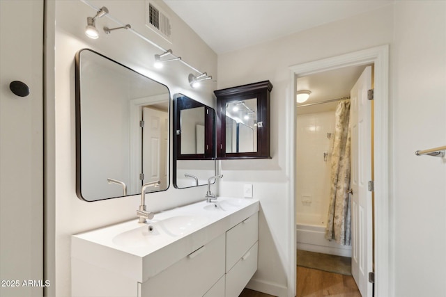 7625 E Camelback Rd Unit B226, Scottsdale, AZ 85251 - full bathroom with double vanity, shower / tub combo with curtain, and wood finished floors