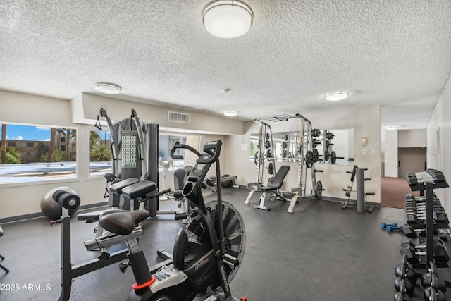 7625 E Camelback Rd Unit B226, Scottsdale, AZ 85251 - workout area with a textured ceiling and baseboards