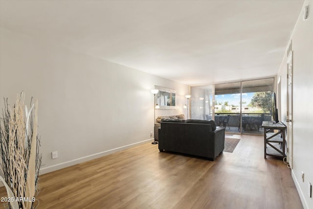 7625 E Camelback Rd Unit B226, Scottsdale, AZ 85251 - living room featuring wood finished floors and baseboards