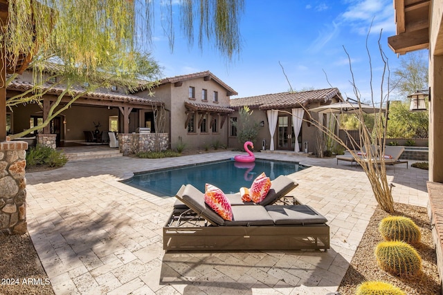 view of pool featuring a patio area