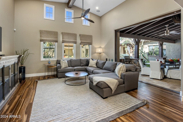 living room with beam ceiling, ceiling fan, and dark wood-type flooring