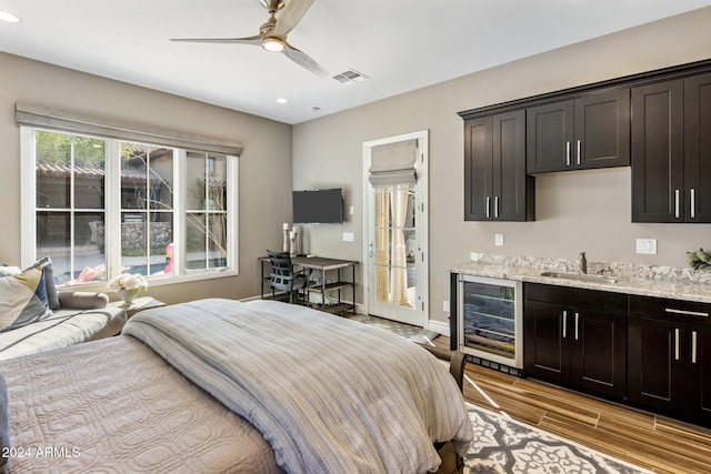 bedroom with access to exterior, ceiling fan, beverage cooler, and sink