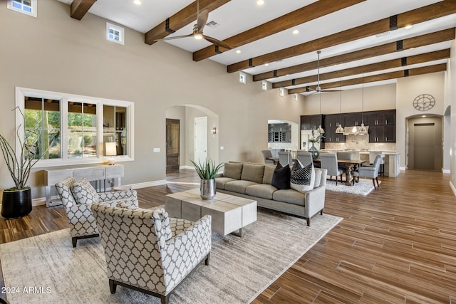 living room with ceiling fan and beam ceiling