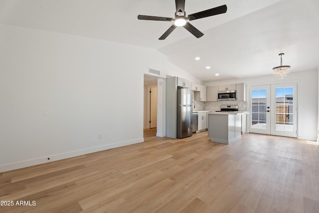 3646 N 69th Ave Unit 55, Phoenix, AZ 85033 - kitchen featuring visible vents, light countertops, lofted ceiling, stainless steel appliances, and backsplash
