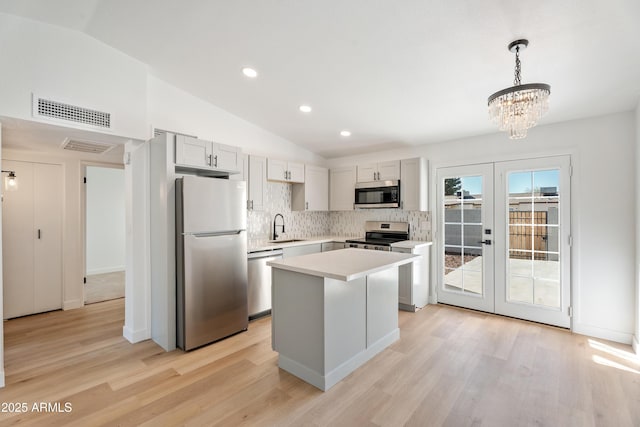 3646 N 69th Ave Unit 55, Phoenix, AZ 85033 - kitchen featuring visible vents, a chandelier, appliances with stainless steel finishes, light countertops, and french doors