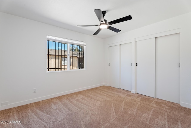 3646 N 69th Ave Unit 55, Phoenix, AZ 85033 - unfurnished bedroom featuring multiple closets, ceiling fan, carpet, and baseboards