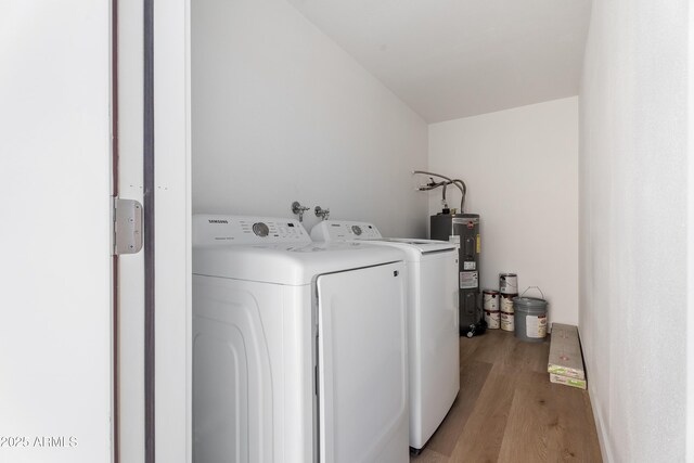 3646 N 69th Ave Unit 55, Phoenix, AZ 85033 - washroom with electric water heater, independent washer and dryer, laundry area, and light wood-style floors