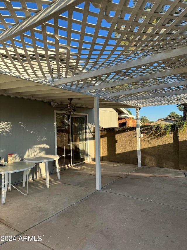 view of terrace featuring a pergola and ceiling fan