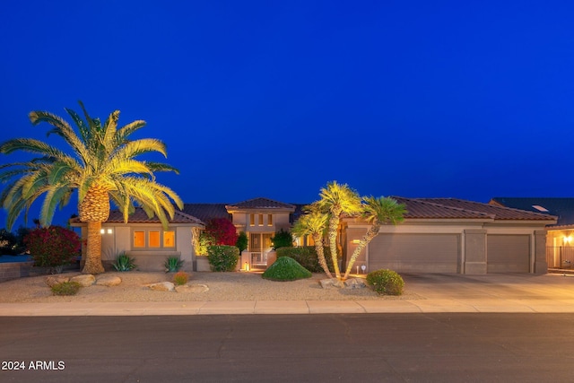 mediterranean / spanish-style house with a garage