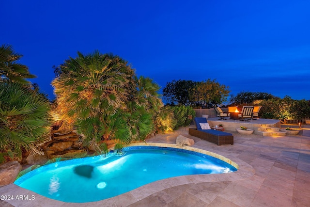 view of pool with a patio and an outdoor fire pit