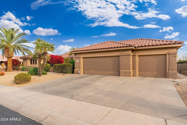 mediterranean / spanish home featuring a garage