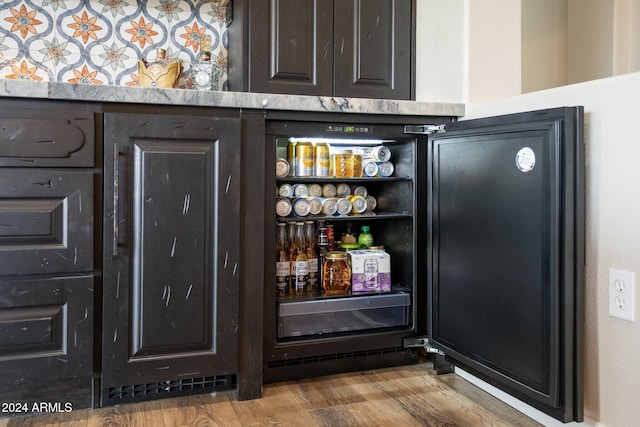 bar with hardwood / wood-style floors