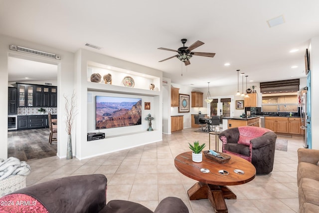 living room with ceiling fan and light tile patterned flooring