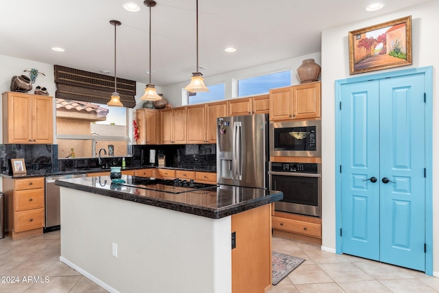 kitchen with sink, a center island, hanging light fixtures, light tile patterned floors, and appliances with stainless steel finishes