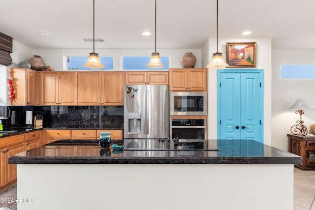 kitchen featuring appliances with stainless steel finishes, tasteful backsplash, a wealth of natural light, and pendant lighting