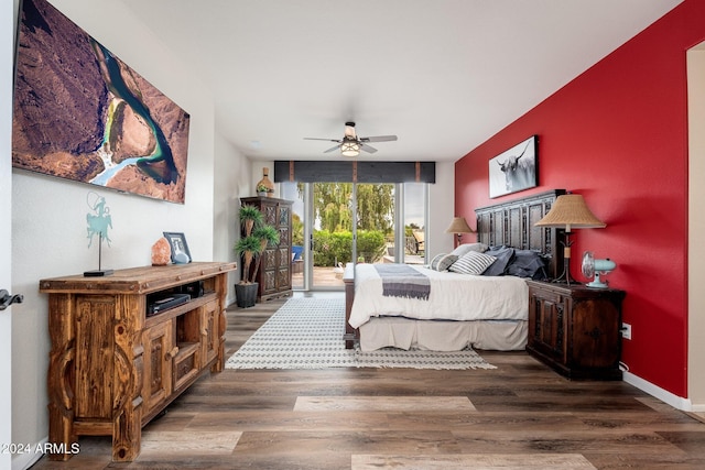 bedroom with ceiling fan, floor to ceiling windows, dark hardwood / wood-style flooring, and access to outside