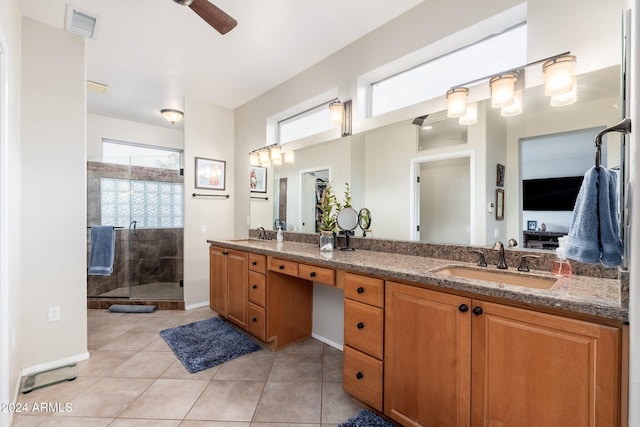 bathroom with vanity, tile patterned floors, a shower with shower door, and a healthy amount of sunlight