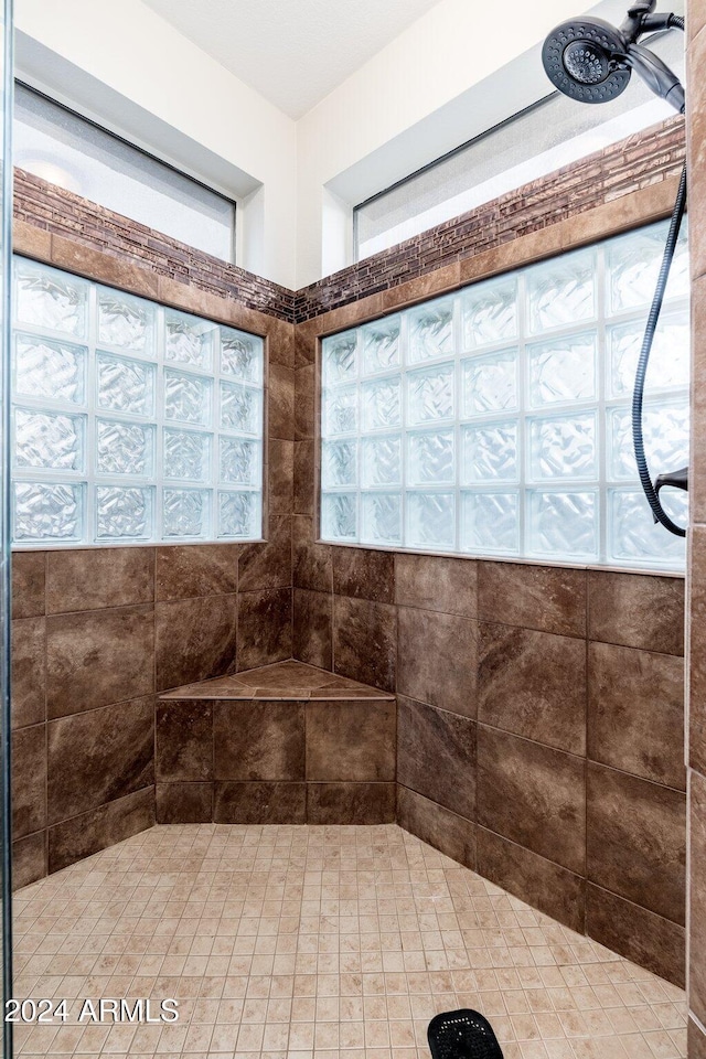 bathroom with a tile shower