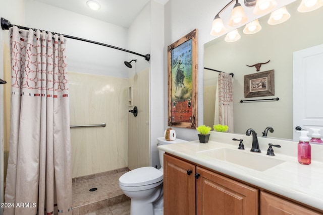 bathroom featuring toilet, vanity, and walk in shower