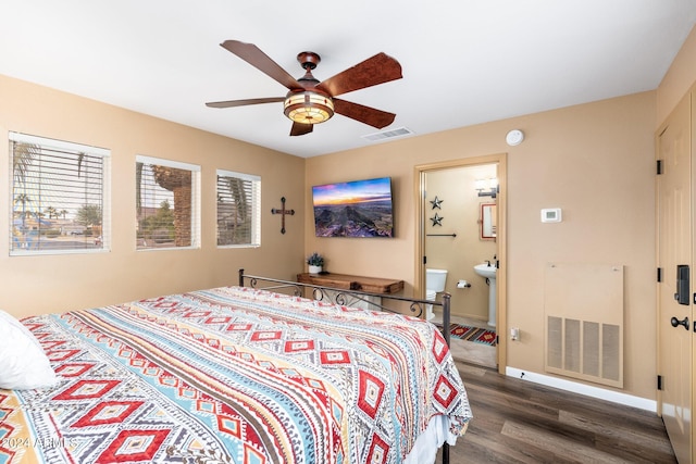 bedroom with ceiling fan, ensuite bathroom, and dark wood-type flooring