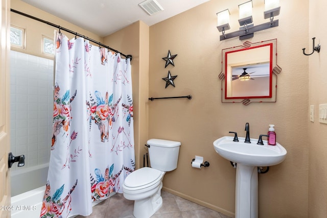 bathroom with tile patterned floors, shower / bathtub combination with curtain, and toilet