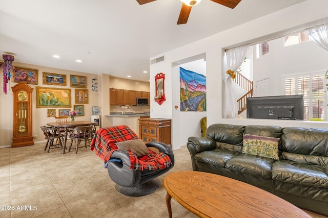 living room featuring light tile patterned floors, recessed lighting, visible vents, baseboards, and stairway