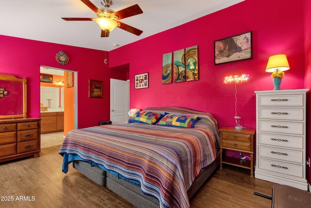 bedroom featuring ceiling fan, wood finished floors, and ensuite bathroom