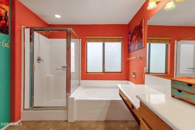 bathroom with a stall shower, tile patterned flooring, vanity, and a bath