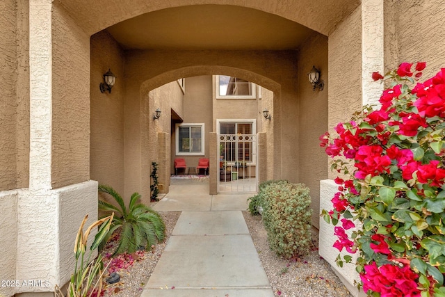 property entrance featuring a patio area and stucco siding