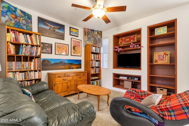 living room featuring built in shelves, tile patterned floors, and a ceiling fan