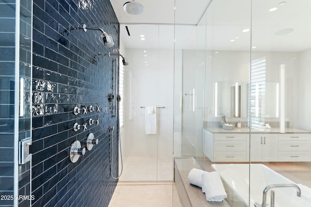 full bathroom with recessed lighting, a shower stall, tile patterned flooring, and vanity