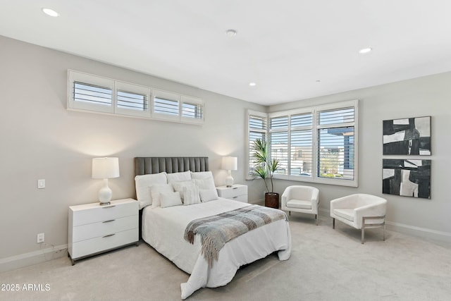 bedroom with baseboards, recessed lighting, and light colored carpet