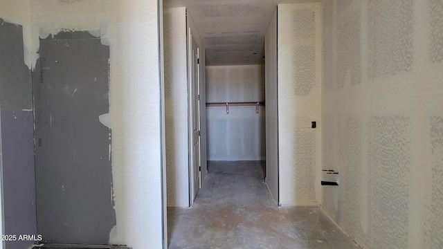 corridor with unfinished concrete floors