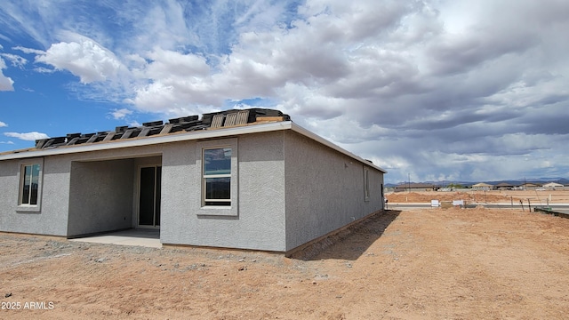 back of house with stucco siding