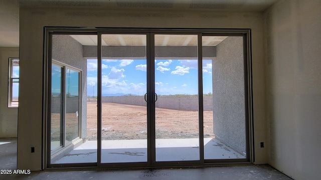 doorway to outside with french doors and concrete flooring