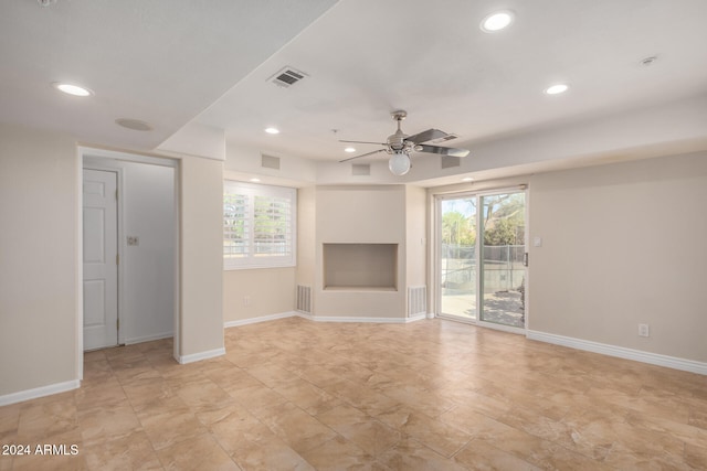 unfurnished living room with ceiling fan