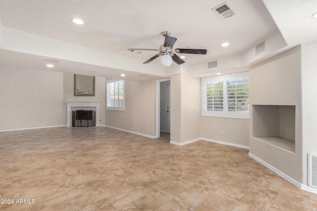 unfurnished living room featuring ceiling fan