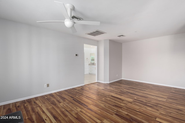 unfurnished room with ceiling fan and dark hardwood / wood-style flooring