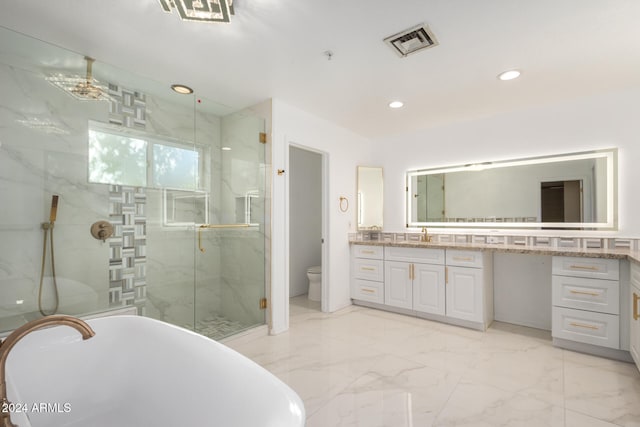 full bathroom featuring separate shower and tub, vanity, and toilet