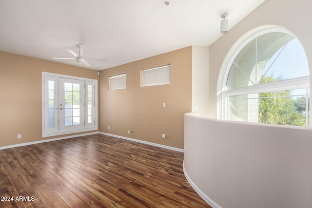 empty room with ceiling fan and dark hardwood / wood-style floors