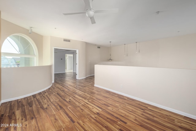 unfurnished room featuring ceiling fan and dark wood-type flooring