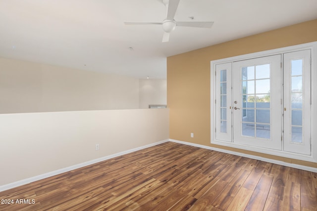 unfurnished room featuring french doors, dark hardwood / wood-style floors, and ceiling fan