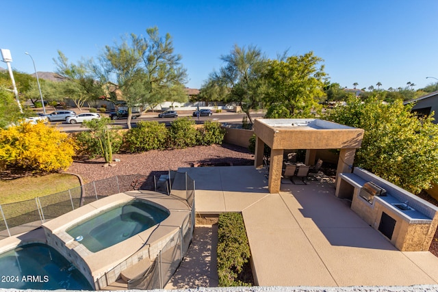 view of patio / terrace featuring an in ground hot tub