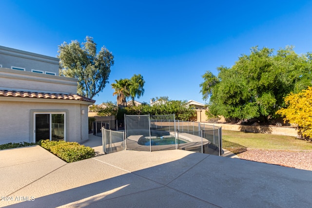 view of patio featuring a fenced in pool